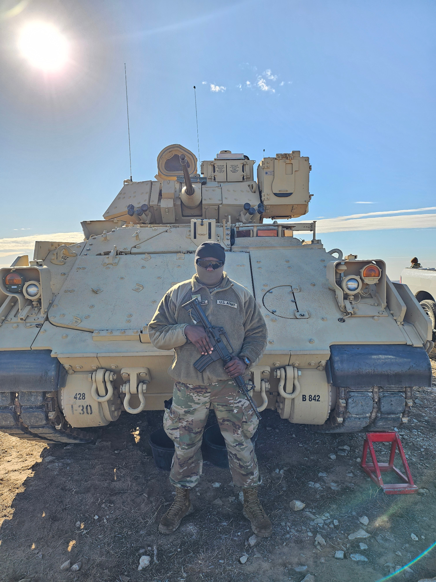 Olardo in front of a Bradley Fighting Vehicle