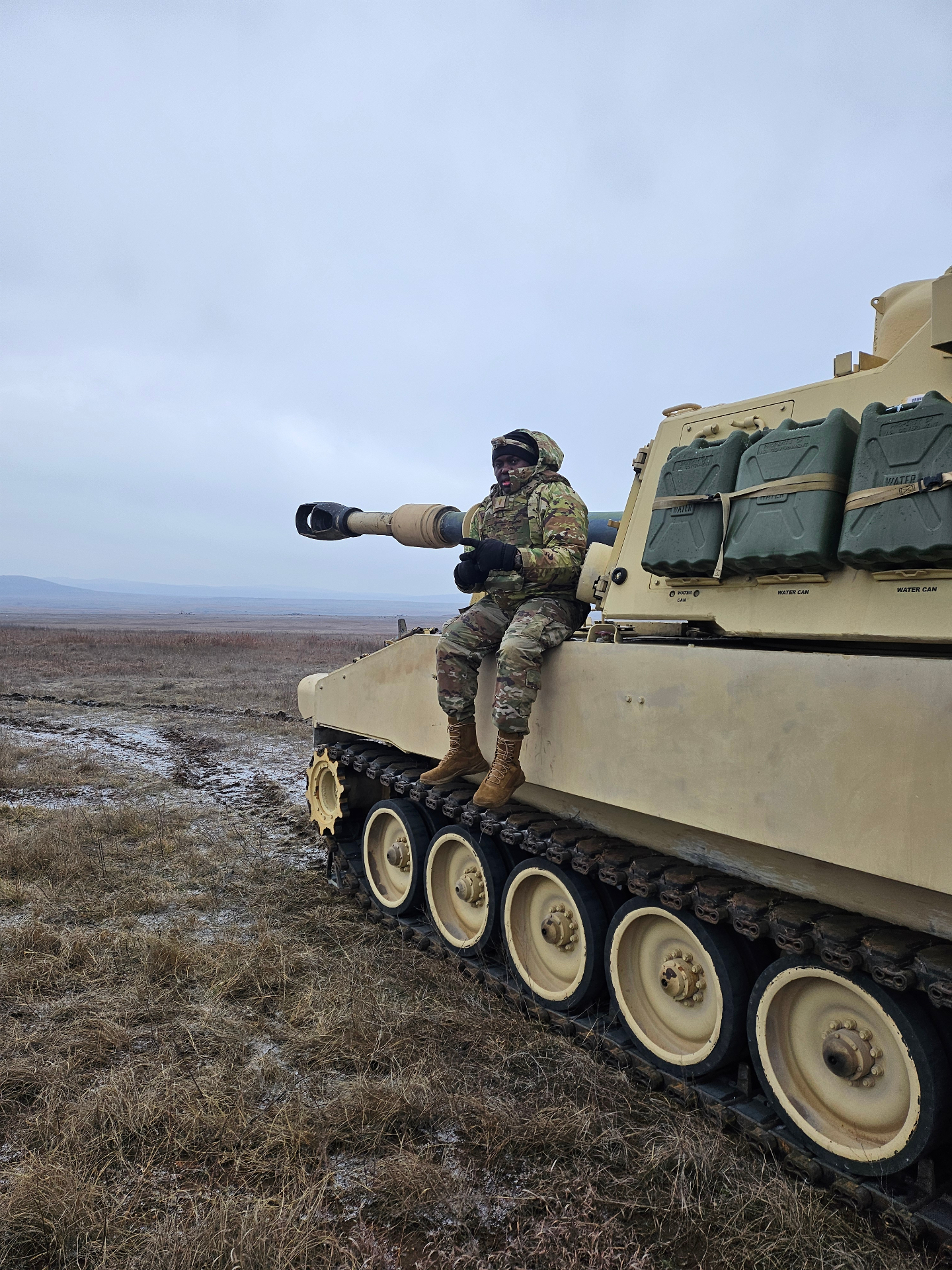 Olardo atop a self-propelled howitzer on a field range